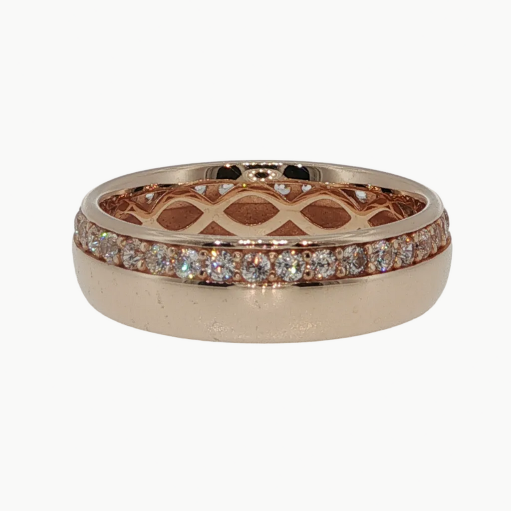 A rose gold band ring featuring a pavé diamond top band and an openwork lattice pattern on the lower half, shown on a light gray reflective surface.