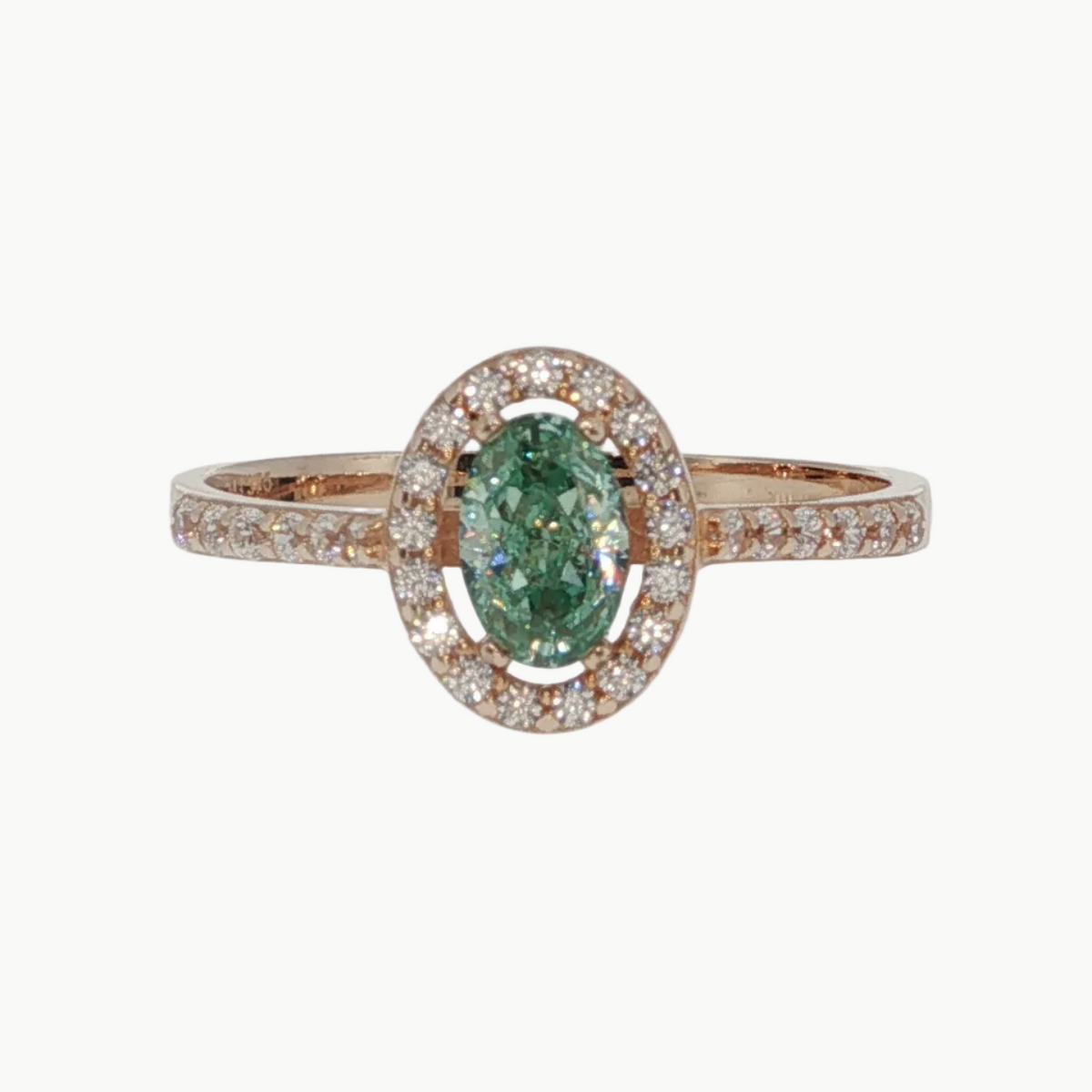 An oval emerald-cut green gemstone halo ring in rose gold, featuring a central green stone surrounded by a halo of small clear stones and a matching rose gold band with pavé-set accents.