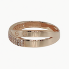 A rose gold band ring with a pavé-set row of small clear stones on one side, photographed on a clean white background.