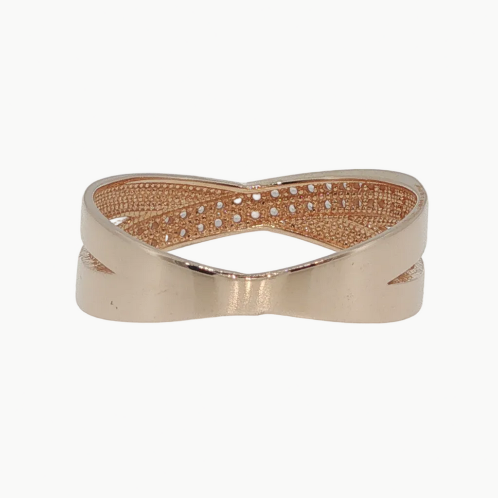 A rose gold band ring with a textured, woven-like center channel set with small clear stones, shown on a clean white background.