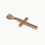 A small cross pendant in rose gold with a textured, diamond-paved appearance, shown on a plain light gray background.