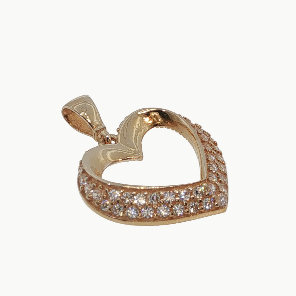 A rose gold heart-shaped pendant with a pavé setting of clear round-cut gemstones, shown on a light gray background.
